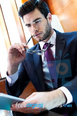 Businessman Using Digital Tablet In Office Stock Photo