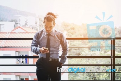 Businessman Using Mobile Phone In Outdoor Office Stock Photo