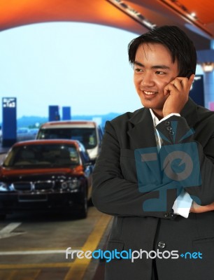 Businessman Waiting For A Taxi At The Airport Stock Photo