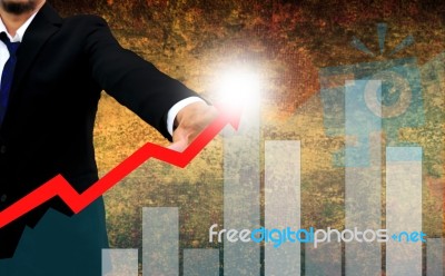 Businessman Watching The Upward Trend Of A Graphic Chart Stock Photo