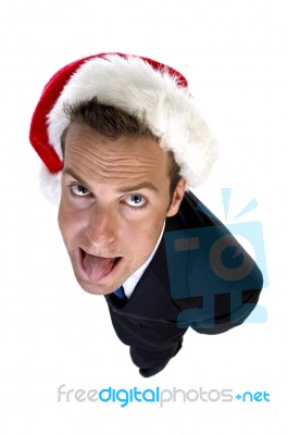 Businessman Wearing Santa Cap And Teasing With Tongue Stock Photo