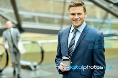 Businessman With Coffee Sipper Stock Photo