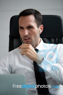 Businessman With Earphones Stock Photo