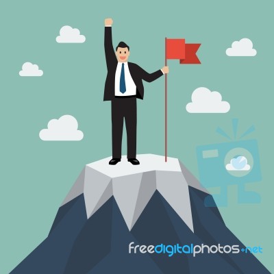 Businessman With Flag On A Mountain Peak Stock Image