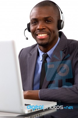 Businessman With Headset And Laptop Stock Photo