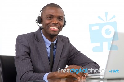 Businessman With Headset And Laptop Stock Photo