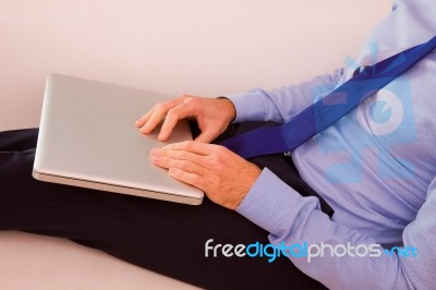 Businessman With Laptop Sitting Couch Stock Photo