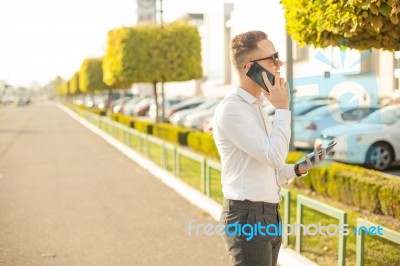 Businessman With Mobile Phone And Tablet In Hands Stock Photo