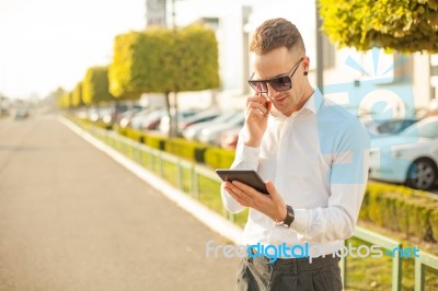 Businessman With Mobile Phone And Tablet In Hands Stock Photo