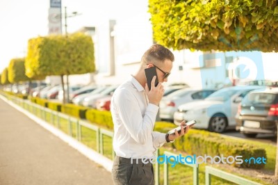 Businessman With Mobile Phone And Tablet In Hands Stock Photo