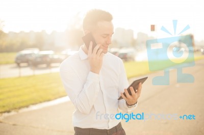 Businessman With Mobile Phone Tablet In Hands Stock Photo