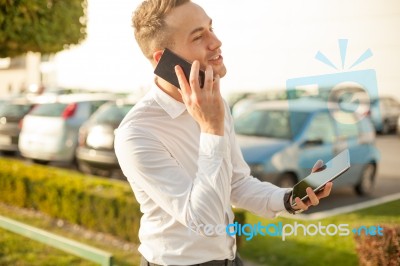 Businessman With Mobile Phone Tablet In Hands Stock Photo