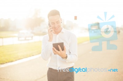 Businessman With Mobile Phone Tablet In Hands Stock Photo