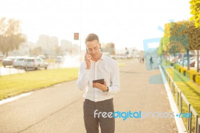 Businessman With Mobile Phone Tablet In Hands Stock Photo