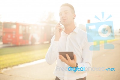 Businessman With Mobile Phone Tablet In Hands Stock Photo