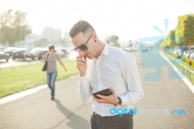 Businessman With Mobile Phone Tablet In Hands Stock Photo