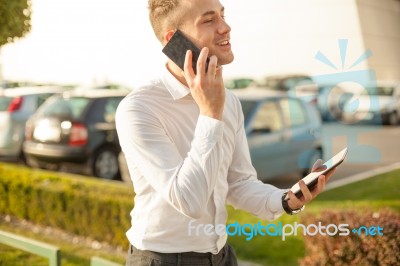 Businessman With Mobile Phone Tablet In Hands Stock Photo