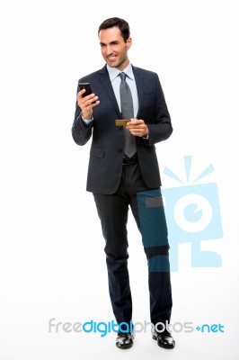 Businessman With Phone And Credit Card Stock Photo