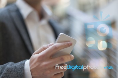 Businessman With Smartphone In Business Building Stock Photo