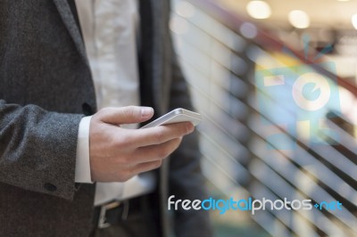 Businessman With Smartphone In Business Building Stock Photo