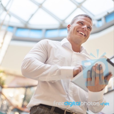 Businessman With Tablet Computer In Modern Business Building Stock Photo