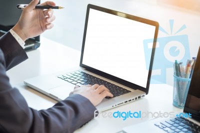 Businessman Working Laptop While Sitting At The Desk, Blurred Ba… Stock Photo