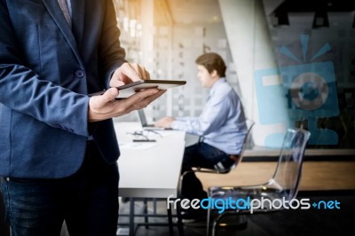 Businessman Working With Tablet In Office, Closeup Stock Photo