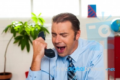 Businessman Yelling During The Phone Call Stock Photo