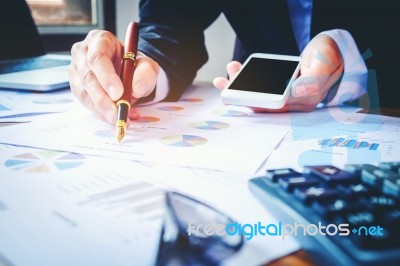 Businessman's Hands With Calculator At The Office And Financial Stock Photo