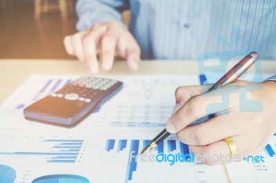 Businessman's Hands With Calculator At The Office And Financial Stock Photo