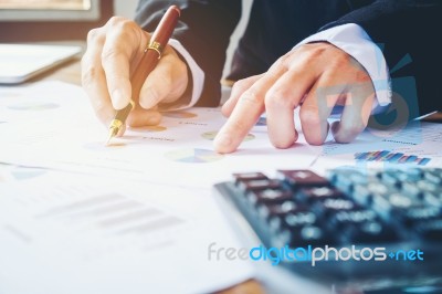 Businessman's Hands With Calculator At The Office And Financial Stock Photo