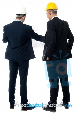 Businessmen Analyzing Construction Plan Stock Photo