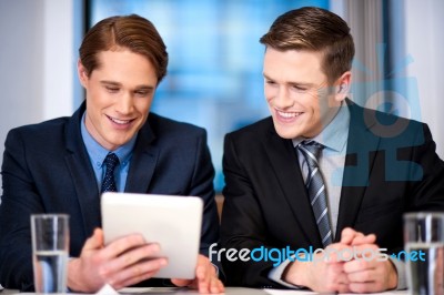 Businessmen Browsing On Tablet Device Stock Photo