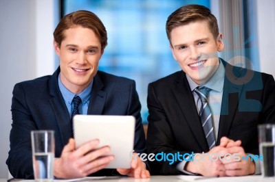 Businessmen Browsing On Tablet Device Stock Photo