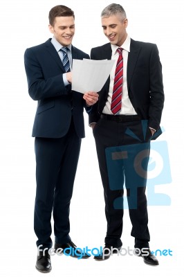 Businessmen Evaluating Deal Documents Stock Photo