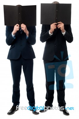 Businessmen Hiding Their Faces With Folder Stock Photo