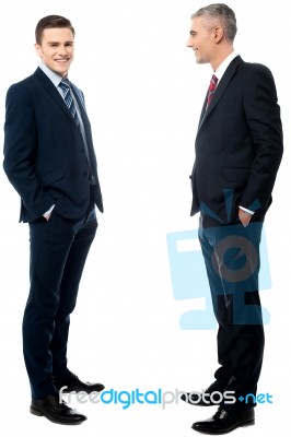 Businessmen Posing With Hands In Pockets Stock Photo