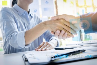 Businessmen Shaking Hands During A Meeting Stock Photo