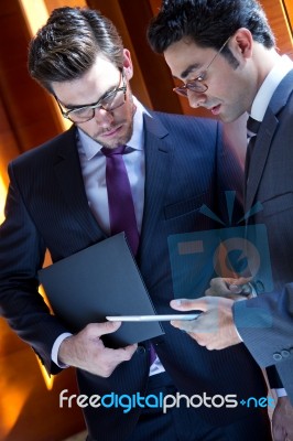 Businessmen With Digital Tablet  In Modern Office Stock Photo