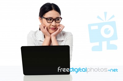 Businesswoman At Her Work Desk, Looking Away Stock Photo