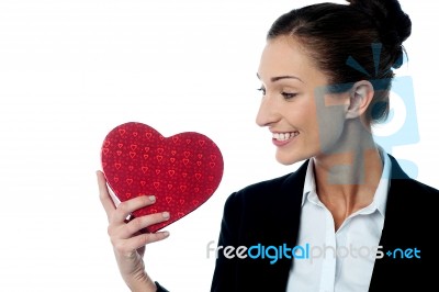 Businesswoman Displaying Her Valentine Gift Stock Photo