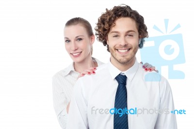 Businesswoman Hiding Behind Her Coworker Stock Photo