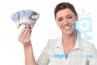 Businesswoman Holding Fan Of Currency Notes Stock Photo