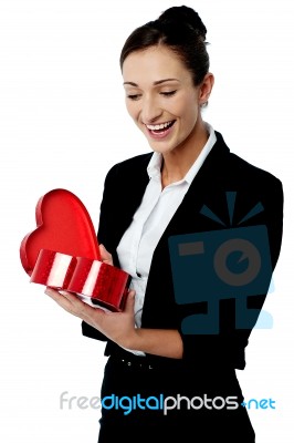 Businesswoman Looking At Her Valentine Gift Stock Photo