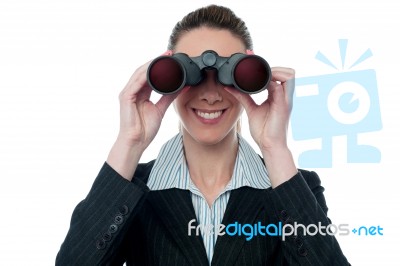 Businesswoman Looking Through Binocular Stock Photo