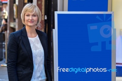 Businesswoman Standing Next To Flip Board Stock Photo