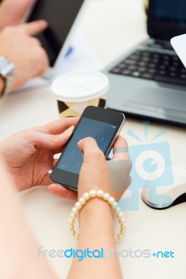 Businesswoman Using Mobile Phone At A Meeting Stock Photo