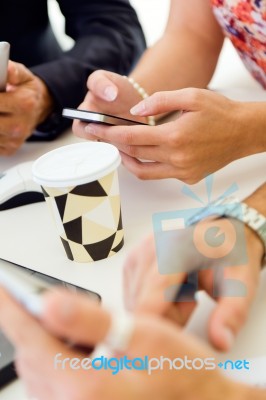 Businesswoman Using Mobile Phone At A Meeting Stock Photo