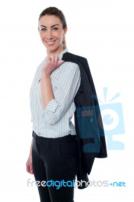 Businesswoman With Coat Slung Over Her Shoulder Stock Photo