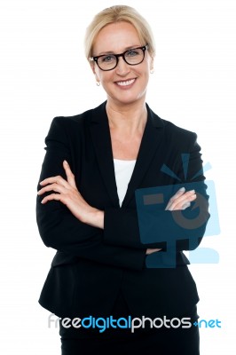 Businesswoman With Crossed Arms Wearing Glasses Stock Photo